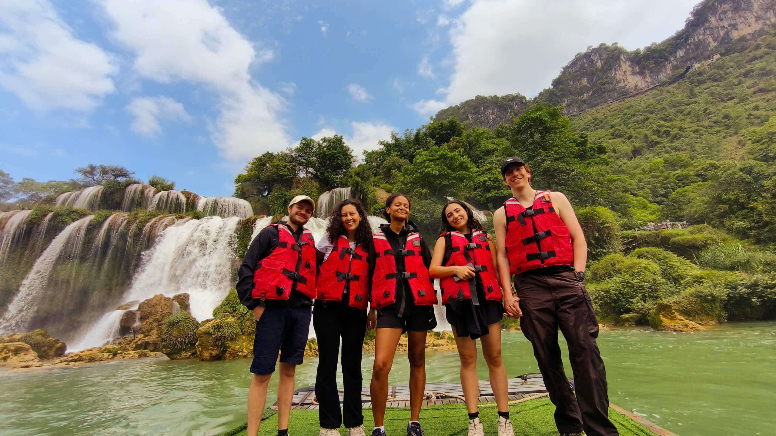 Tourists admiring the majestic Ban Gioc Waterfall on the Cao Bang motorbike loop.