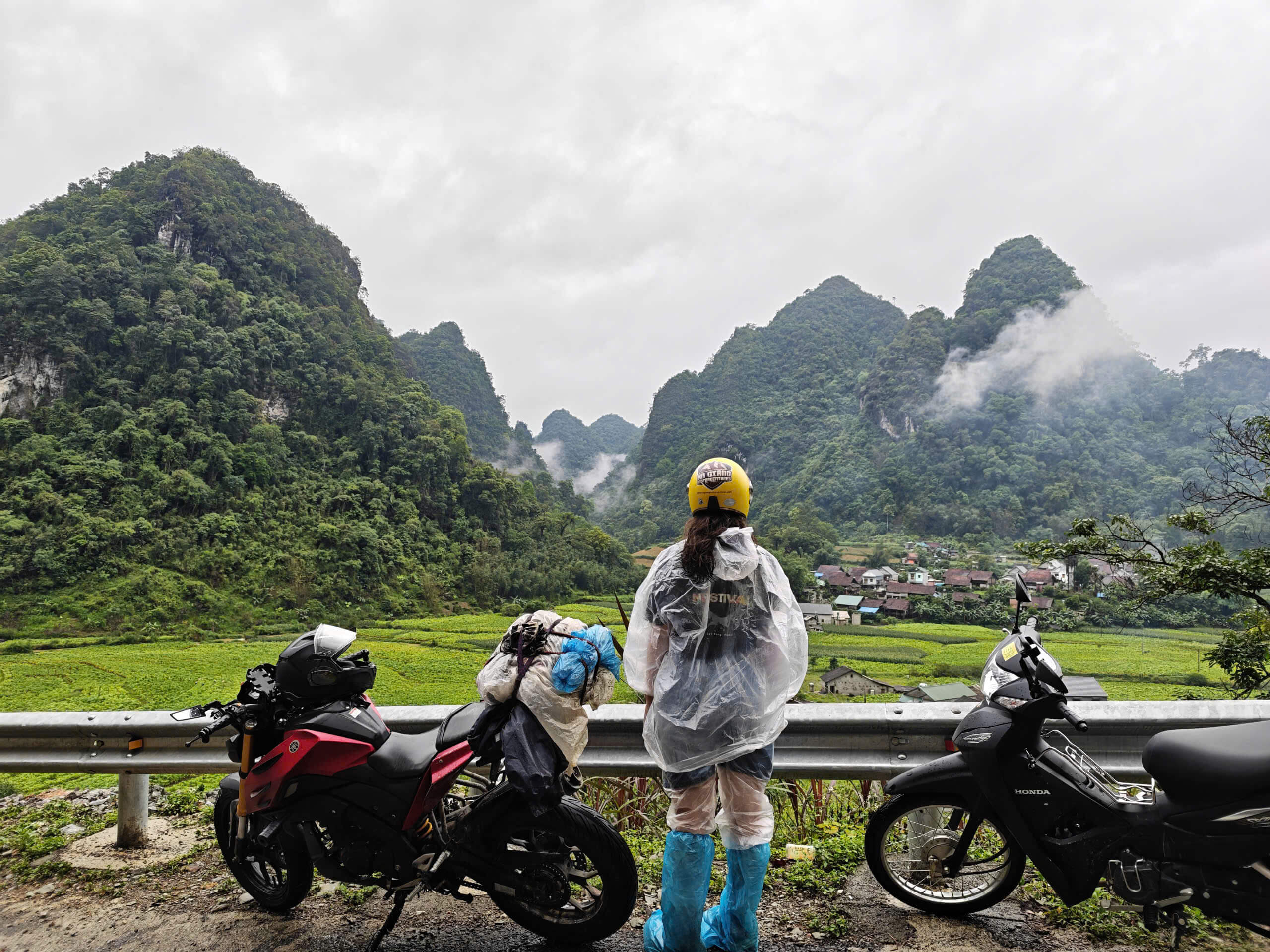 A girl during Cao Bang Loop tour with Motorventures, on a rainy day,
